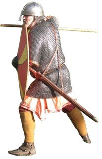 English Warrior AD793‑979 An aristocratic warrior with a domed helmet, lenticular round shield and mail shirt. He fights with a spear and carries an English sword on a baldric.