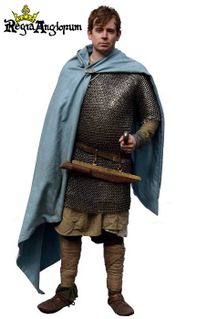 English Warrior AD900‑1079 A professional warrior, with a mail shirt, sword and seax. His woad dyed cloak is closed by an typical English disc brooch.