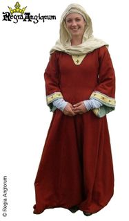 English Thegnly Woman AD1042‑1179 An aristocratic women wearing a deep madder dyed dress with its wide sleeves cut short to show the cuffs of the linen undershift beneath. The dress is decorated with embroidered Christian cross motifs.